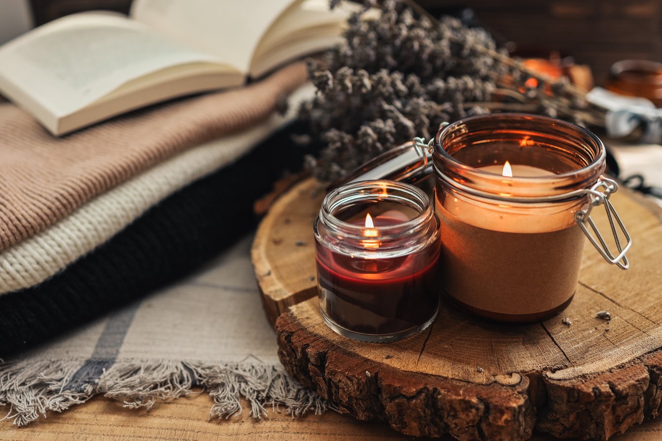 Burning candles, book and lavender, aesthetic autumn photo